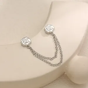 Close-up detail of silver rose magnetic buckle with double chain anti-glare fastener.