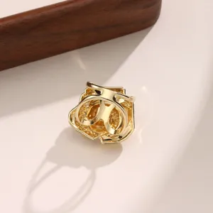 Exquisite gold 3D flower scarf buckle detail close-up, elegant metallic texture display.