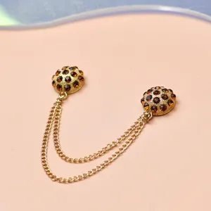 Close-up detail of rhinestone magnetic chain buckle for clothing adjustment and anti-glare use.