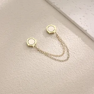 Detailed close-up of a golden magnetic clasp with double chains, elegant clothing accessory.