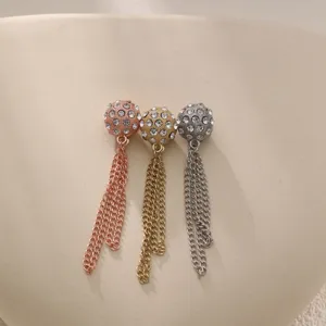 Detailed view of versatile rhinestone magnetic cuff and pants clips with elegant hanging chains.