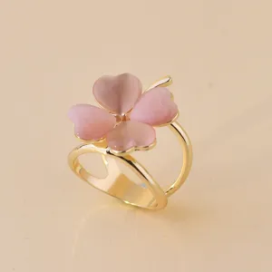 Charming four-leaf clover scarf buckle featuring pink heart-shaped petals and gold ring.