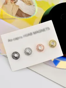Detail shot of sparkly rhinestone magnetic hijab pins in four elegant metallic colors.