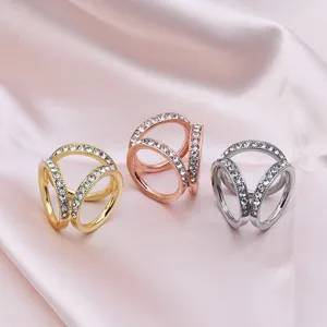 Close-up shot of triple ring silk scarf buckles featuring sparkling rhinestones in detail.