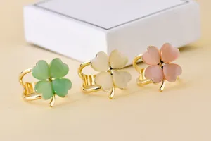 Close-up of sweet four-leaf clover scarf rings in green, white, and pink with gold tone.