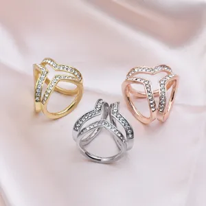 Close-up detail of three elegant alloy scarf rings with glittering rhinestones on satin.
