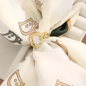 Gold metal scarf ring buckle for women, versatile clothes corner knot fastener and T-shirt hem clip.