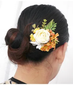 Close-up detail of vintage autumn floral hair accessory, elegant artificial rose updo piece.