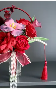 Detailed view of artificial wedding bridal bouquet with red roses and pearls, close up shot.