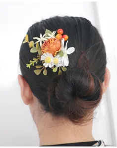 Close-up detail of vintage autumn floral hair accessory with rose and berries for updo.