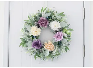 Detailed close-up of European style artificial peony wreath hanging on door seasonal decor