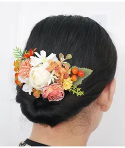 Detail view of vintage autumn floral hair comb with artificial roses and berries for bun.