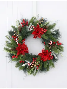 Christmas wreath door hanging with red poinsettias pine cones and berries for holiday decor