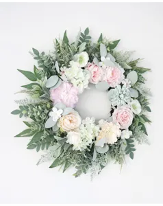 Artificial peony rose floral wreath detail close-up view, elegant pink flower home wall decor.