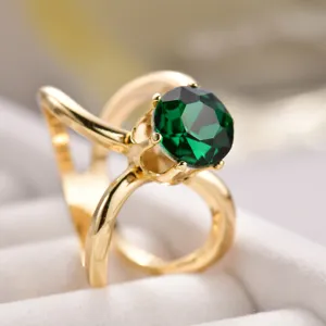Elegant gold-tone crystal scarf buckle ring with stunning green glass stone for women fashion.