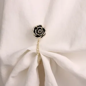 Exquisite black camellia flower magnetic brooch and clothing corner fastener with delicate chain.