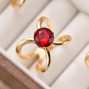 Exquisite crystal bow ring and silk scarf buckle detail shot showing golden polish.