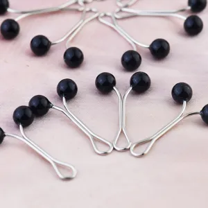 Pearl hijab scarf clips with black beads, secure fastening pins for women fashion accessories.