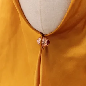 Exquisite rose gold magnetic scarf buckle detail shot featuring an elegant floral design.