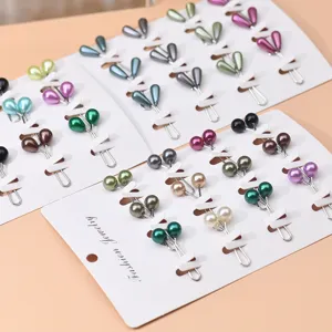 Detail shot of colorful pearl hijab pins set on white cards, beautiful scarf clips for women.