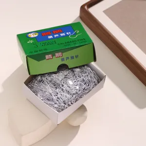Detailed view of a box of white calabash safety pins with green brand packaging.