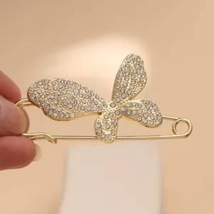 Gold butterfly rhinestone safety pin brooch shawl buckle for decorative clothing accessory.
