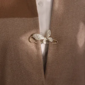 Exquisite rhinestone butterfly brooch detail view, elegant gold alloy safety pin decor.