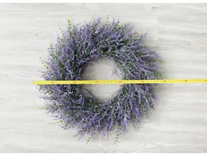 Artificial lavender wreath detail shot, wall hanging floral decor for wedding and home decoration.