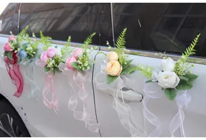 Detail view of artificial rose wedding car door handle decoration flowers with delicate ribbons.