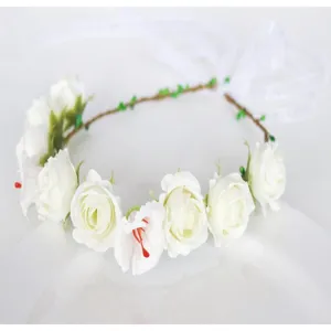 Close-up detail of white rose floral crown with ribbons, perfect for photography props.