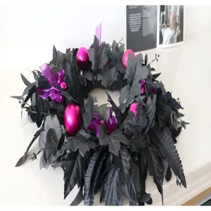 Black artificial Halloween maple leaf wreath with purple leaves and pink ornaments for decor