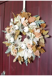 Autumn Thanksgiving maple leaf pinecone wreath with white pumpkins for door and wall decor.