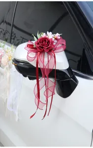 Wedding car rearview mirror artificial red rose flower decoration with elegant ribbon bow design.
