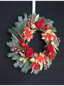 Festive artificial Christmas wreath with red roses, berries, and gold balls for door decor.