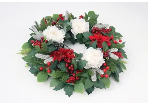 Detailed view of the artificial Christmas wreath featuring white peonies and red berries.