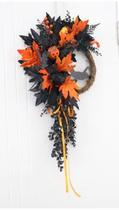 Halloween decorative wreath detail featuring black crow, pumpkins, and autumn maple leaves.