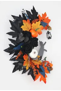 Halloween crescent cat wreath detail view, artificial floral garland for holiday home decor.