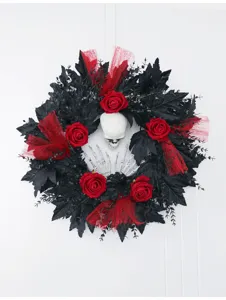 Detailed view of Halloween black wreath with red roses, skull and skeleton hands wall decor.
