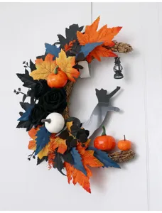 Halloween crescent moon wreath detail showing black cat silhouette and artificial maple leaves.