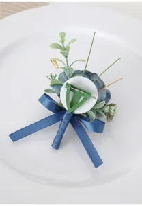 Detailed back view of blue artificial flower boutonnière with ribbon for wedding and events.