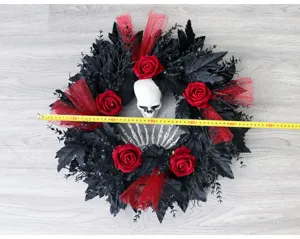 Close-up detail view of the Halloween wreath showing size with measuring tape, skull and roses.
