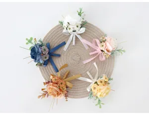 Close-up detail presentation of colorful artificial flower boutonniere set arranged nicely.