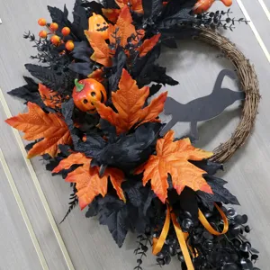 Halloween decorative wreath featuring black and orange leaves, pumpkins, crow, and cat silhouette.