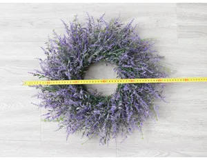 Detailed view of artificial purple lavender wreath on wooden surface showing sizing.