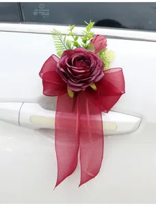 Wedding car door handle artificial rose flower bow decoration detail close-up shot.