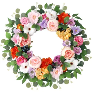 Beautiful artificial floral wreath with colorful flowers and eucalyptus leaves for home and wedding decor.
