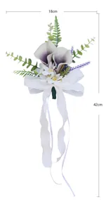 Details of wedding car decoration artificial flower with elegant white bow and leaf accents.