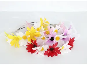 Colorful fabric daisy flower headband with white ribbon, perfect for wedding flower girl details.