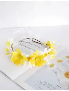 Floral crown detail shot with white and yellow daisies and ribbon, fairy forest style.