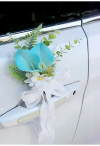 Detail shot of cyan calla lily artificial wedding car door handle flower decoration ribbon.